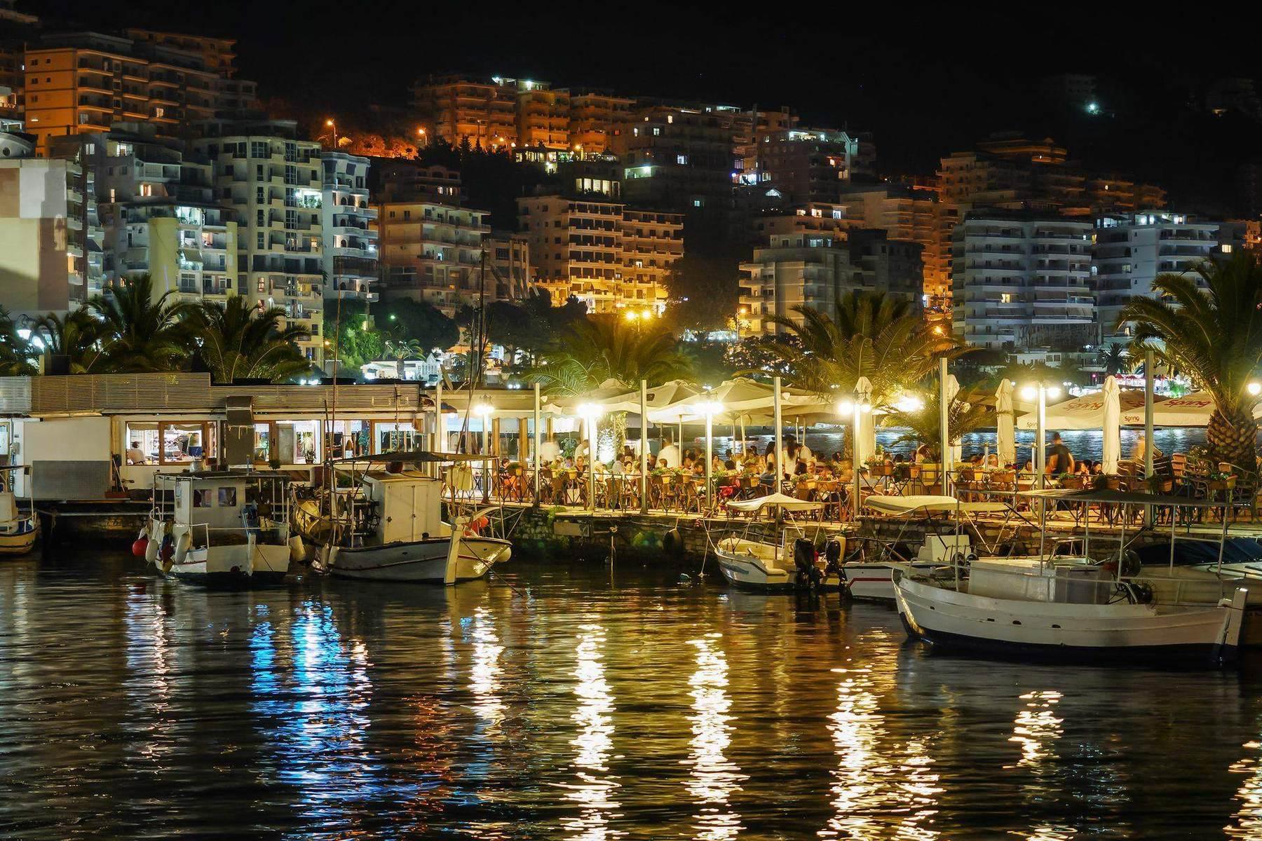 Saranda waterfront at night with boats and promenade lights, Albanian Riviera
